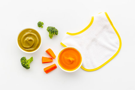 Baby feeding with fruits food and fresh vegetables, top view