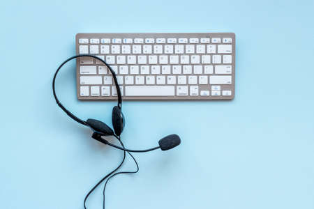 Voip headset and computer laptop on offise desk. Commenication it support call centerの写真素材