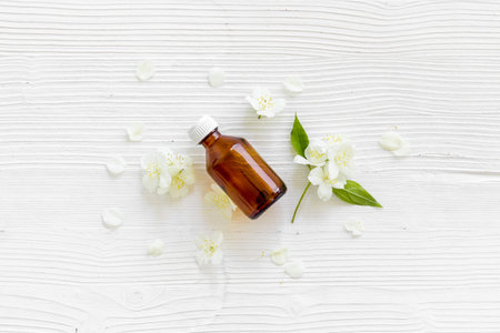 Jasmine flowers with essence oil bottle. Top view