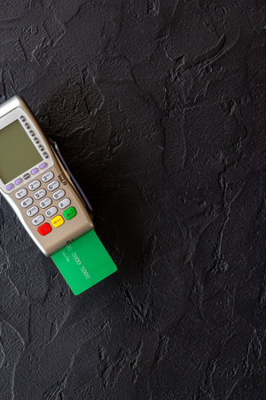 E-commerce and payment concept. Pos terminal with credit cards top view
