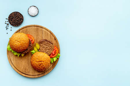 Bbq hamburgers with beef steak on serving board, top viewの写真素材