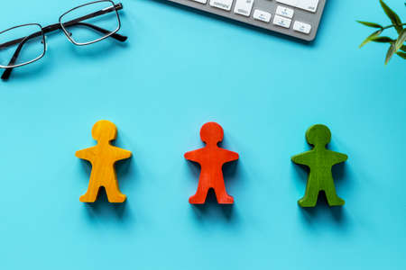 Coflict resolution concept. Mediator wooden man figure between opponents sidesの写真素材