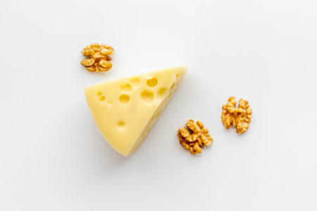 Piece of cheese maasdam on kitchen table