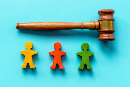 Numan wooden figurines with judge gavel. Resolving conflict situationの写真素材