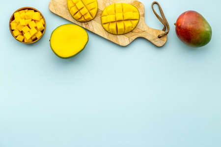 Mango fruits and mango cubes in bowl. Tropical breakfast. Overhead viewの写真素材