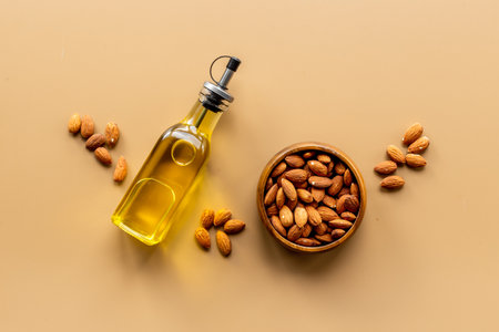 Almond nut oil in glass bottle with almond nuts. Extra virgin essence oilの写真素材