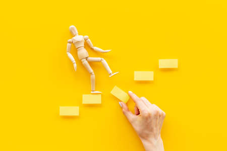 Man mannequin figure falling down from stairs. Accident failure and fiasco in business concept.の写真素材