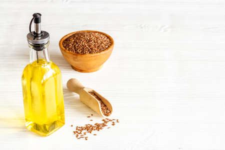 Sesame oil in glass bottle with sesame seeds. Extra virgin oil for food or cosmetic productsの写真素材