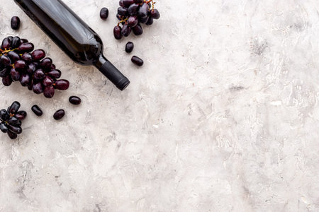Winery background. Red wine bottle with grapes