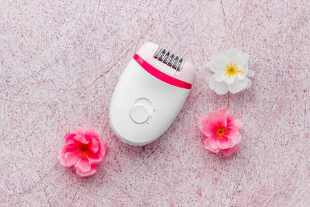 White epilator with flowers - set for hair removal, top viewの写真素材