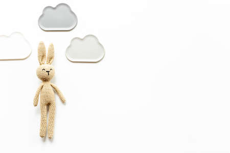 Knitted baby toy rabbit for newborn - background for baby showerの写真素材