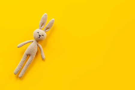 Knitted baby toy rabbit for newborn - background for baby showerの写真素材