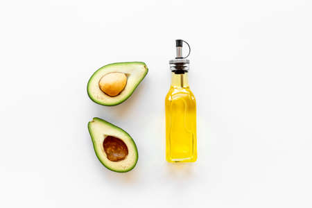 Bottle of avocado essence oil with raw avocadoの写真素材