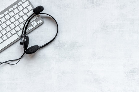 Communication support call center. Voip headset and computer laptop, top view