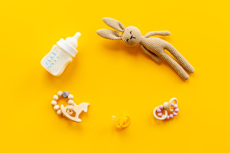 Knitted baby toy bunny with milk bottle, top view