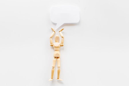 Wooden man figure with speech bubble banner