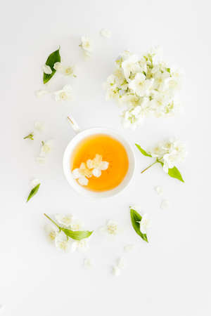 Tea in a cup with jasmine flowers. Herbal tea top viewの写真素材
