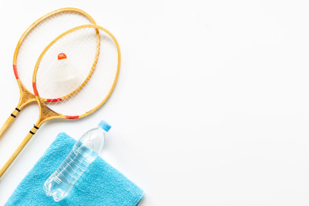 Sports equipment with badminton rackets towel and water