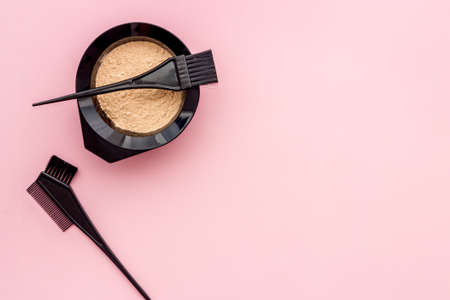 Mixing hair dye in bowl with brush, top viewの写真素材