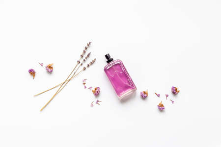 Perfume bottle with aroma flowers and leavesの写真素材