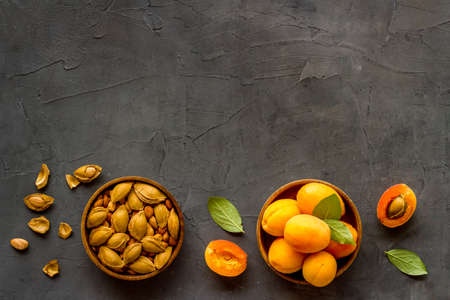 Apricots and apricot pits kernel in bowl. Overhead viewの写真素材