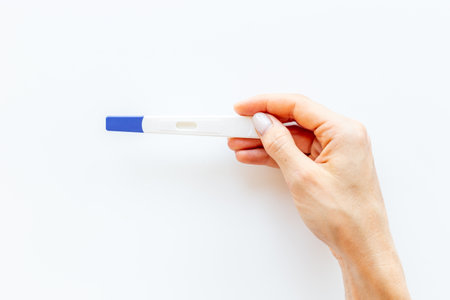 Pregnancy test in female hand. Morherhood and pregnancy conceptの写真素材