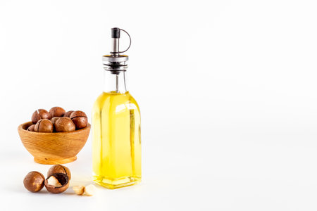 Macadamia essence oil with macadamia nuts. Organic product for food or cosmeticの写真素材
