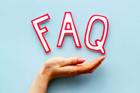 Hands with faq - frequently asked questions - paper letters, top viewの写真素材