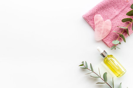 Rose gua sha massage stone with essential oil for lifting face and wellnessの写真素材