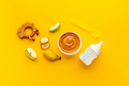 Baby fruits vegetables food with milk bottle and toyの写真素材