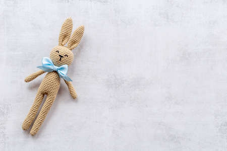 Plush toy rabbit for newborn baby. background for baby shower.の写真素材