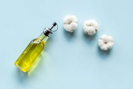 Cottonseed oil in glass bottle with cotton flowers. Healthcare natural cosmeticの写真素材