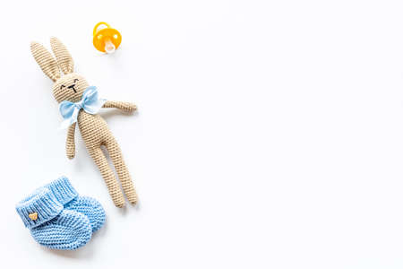 Knitted baby toy rabbit with newborn booties shoes, top viewの写真素材