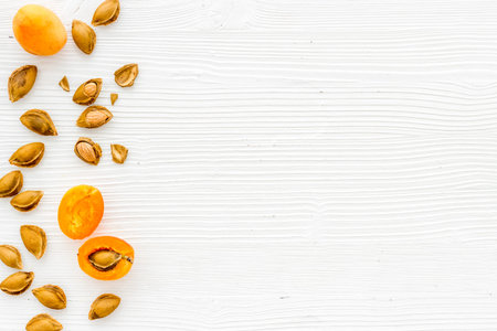 Flat lay of apricot kernel with ripe apricot fruitsの写真素材