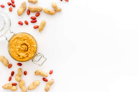 Bowl of peanut butter with nuts on kitchen table. Overhead viewの写真素材