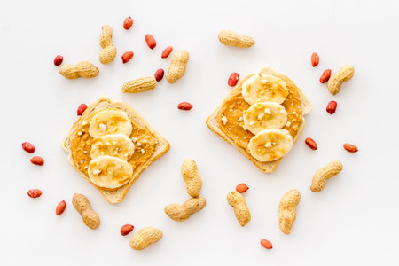 Breakfast with peanut butter sandwiches on white bread, top view