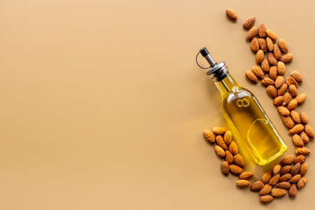 Almond nut oil in glass bottle with almond nuts. Extra virgin essence oilの写真素材