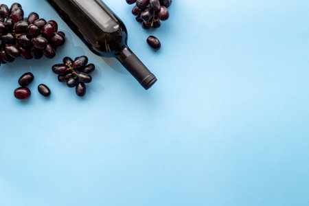 Red wine bottle with grape. Overhead view