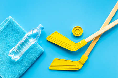 Competitive sports equipment with hockey sticks towel and bottle of water. Top viewの写真素材