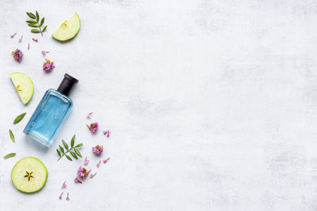 Perfume bottle flat lay with fragrance ingredients, top view