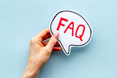 Hands with faq word on paper bubble. Frequently asked questions conceptの写真素材