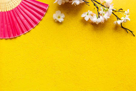 Chinese hand fan with cherry blossom branch. Top viewの写真素材