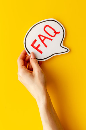 Hands with faq - frequently asked questions - text on paper bubble