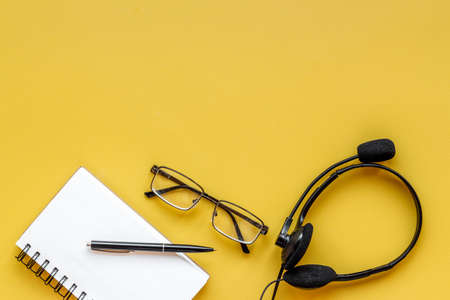Communication support call center. Voip headset on offise deskの写真素材