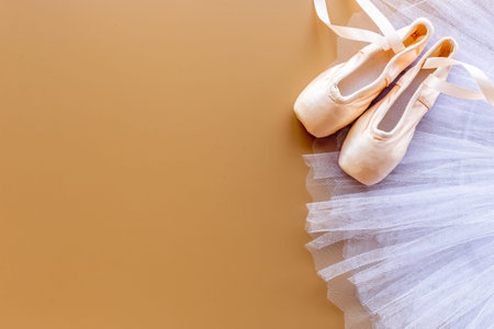 White ballet tutu skirt and beige pointe shoes with ribbon