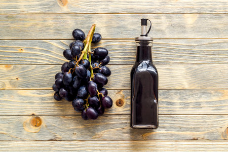 Bottle of balsamic vinegar with bunch of fresh grapesの写真素材