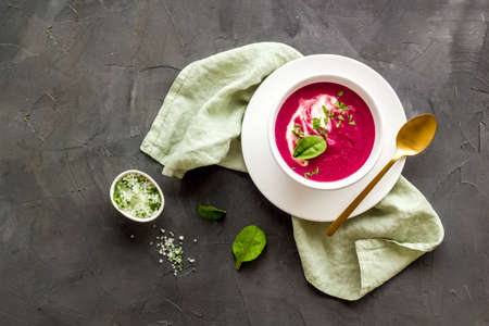 Red vegetarian beet root cream soup with herbal basil saltの写真素材