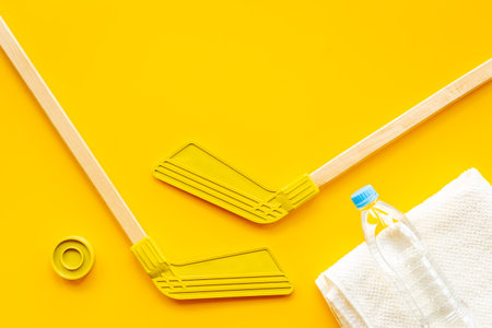 Competitive sports equipment with hockey sticks towel and bottle of water. Top viewの写真素材