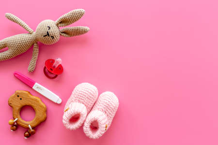 Pink baby girl booties with pregnancy test. Morherhood and pregnancy conceptの写真素材