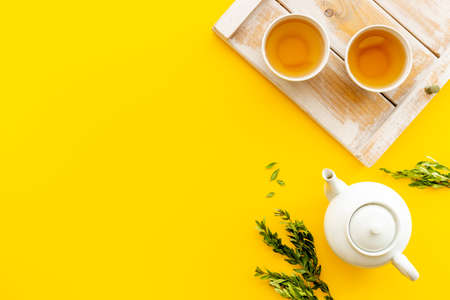 Asian food and drink background white teapot and black tea in two cupsの写真素材